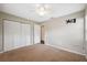 Bedroom features a ceiling fan, closet, and carpet at 8306 N Gomez Ave, Tampa, FL 33614