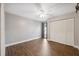 Neutral bedroom features wood-look tile flooring, a ceiling fan, and a closet at 8306 N Gomez Ave, Tampa, FL 33614
