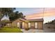 Inviting single-story home with a well-kept lawn and colorful sunset backdrop at 8306 N Gomez Ave, Tampa, FL 33614