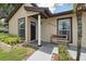 Charming front porch with stylish bench seating and updated exterior at 8306 N Gomez Ave, Tampa, FL 33614