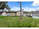 Charming single-story home with manicured lawn and mature landscaping at 8306 N Gomez Ave, Tampa, FL 33614