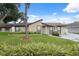 Inviting single-story home featuring a well-manicured lawn and lush landscaping at 8306 N Gomez Ave, Tampa, FL 33614