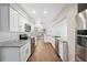 Bright kitchen features granite countertops, stainless steel appliances, and wood-look tile flooring at 8306 N Gomez Ave, Tampa, FL 33614