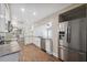 Bright kitchen features granite countertops, stainless steel appliances, and wood-look tile flooring at 8306 N Gomez Ave, Tampa, FL 33614