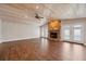 Spacious living room with vaulted ceilings, stone fireplace, and wood-look tile floors at 8306 N Gomez Ave, Tampa, FL 33614