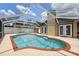Sparkling in-ground pool in a screened enclosure with patio space at 8306 N Gomez Ave, Tampa, FL 33614