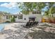 A charming backyard showcases a swimming pool, dining and lounge furniture, with a patio area at 8500 144Th Ln, Seminole, FL 33776
