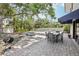 Private backyard with in-ground pool, brick-paved patio, outdoor dining set, and lush landscaping at 8500 144Th Ln, Seminole, FL 33776