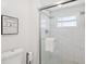 The bathroom features a glass-enclosed shower with white marble tile and a modern showerhead at 8500 144Th Ln, Seminole, FL 33776