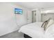 Bedroom featuring a king-size bed, flat screen television and an ensuite bathroom with a closet at 8500 144Th Ln, Seminole, FL 33776