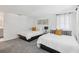 Spacious bedroom featuring two beds, neutral walls, and easy access to the bathroom at 8500 144Th Ln, Seminole, FL 33776