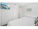 Comfortable bedroom featuring neutral tones, a wall mounted TV, and easy access to the bathroom at 8500 144Th Ln, Seminole, FL 33776