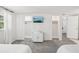 Bright bedroom featuring plush carpeting, twin beds, and dual closets with modern closet doors at 8500 144Th Ln, Seminole, FL 33776