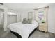 Well-lit bedroom featuring a king-size bed, neutral-toned decor, and a window with sheer curtains at 8500 144Th Ln, Seminole, FL 33776