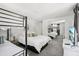 Bedroom with bunk bed, large bed, dresser with television, and mirrored closet at 8500 144Th Ln, Seminole, FL 33776