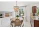 Bright dining area features a round table, chandelier, and a window view of the backyard at 8500 144Th Ln, Seminole, FL 33776