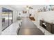 Dining room with views of the pool, staircase, and features a very long table with seating at 8500 144Th Ln, Seminole, FL 33776