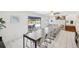 Bright dining room opens to a pool view and features a long table with seating at 8500 144Th Ln, Seminole, FL 33776