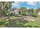 Two-story home featuring a brick and vinyl exterior with landscaped yard, a front-entry two car garage, and large front-yard trees at 8500 144Th Ln, Seminole, FL 33776