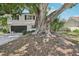 Spacious two-story home with a mature tree in the yard, and an attached two-car garage at 8500 144Th Ln, Seminole, FL 33776