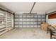 Uncluttered garage space with metal garage door, built-in storage shelves and ample room at 8500 144Th Ln, Seminole, FL 33776