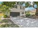 Two-story home with a two-car garage and a long driveway, enhanced with a brick trim at 8500 144Th Ln, Seminole, FL 33776