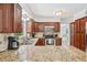 Classic kitchen featuring granite countertops, stainless steel appliances and wood cabinets at 8500 144Th Ln, Seminole, FL 33776