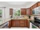 Classic kitchen featuring granite countertops, stainless steel appliances and wood cabinets at 8500 144Th Ln, Seminole, FL 33776