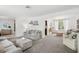 Open-concept living room showcasing neutral tones, comfortable seating, and large windows at 8500 144Th Ln, Seminole, FL 33776