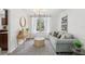 Bright living room with a decorative rug, modern lighting fixture, console table, and comfortable seating arrangement at 8500 144Th Ln, Seminole, FL 33776