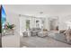 Spacious living room featuring a neutral color palette, plush carpeting, and abundant natural light at 8500 144Th Ln, Seminole, FL 33776