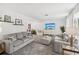 Bright and inviting living room with two sofas, a decorative coffee table, and large windows at 8500 144Th Ln, Seminole, FL 33776