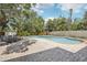 Large private pool surrounded by a brick patio, lush landscaping, and lounge chairs for relaxing at 8500 144Th Ln, Seminole, FL 33776