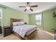 Comfortable bedroom featuring carpet flooring, a ceiling fan, and large window at 8607 Tidal Breeze Dr, Riverview, FL 33569