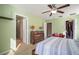 Cozy bedroom features a ceiling fan, walk-in closet, and en-suite bathroom at 8607 Tidal Breeze Dr, Riverview, FL 33569
