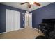 Bedroom featuring unique wallpaper, a ceiling fan, and closet space at 8607 Tidal Breeze Dr, Riverview, FL 33569