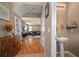 Inviting entryway with a half bath, opening to the living room and beautiful laminate flooring at 8607 Tidal Breeze Dr, Riverview, FL 33569