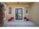 Cozy front porch decorated with beautiful plants, a glass storm door, and classic shutters at 8607 Tidal Breeze Dr, Riverview, FL 33569
