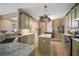 Well-equipped kitchen with island, granite countertops and modern appliances at 8607 Tidal Breeze Dr, Riverview, FL 33569