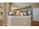 Bright kitchen with island, stainless steel refrigerator and light green cabinetry at 8607 Tidal Breeze Dr, Riverview, FL 33569