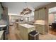 An open-concept kitchen featuring an island with granite countertops and stainless steel appliances at 8607 Tidal Breeze Dr, Riverview, FL 33569