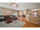 Spacious living area with laminate flooring, a cozy couch, and backyard access at 8607 Tidal Breeze Dr, Riverview, FL 33569
