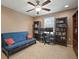 Functional home office featuring a blue futon, a desk, and built-in bookshelves at 8607 Tidal Breeze Dr, Riverview, FL 33569