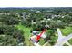 An aerial view shows the home with a spacious backyard, surrounded by lush trees and neighboring houses at 9413 Forest Hills Dr, Tampa, FL 33612