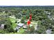 An aerial view showcases this charming home nestled among lush trees in a serene, green neighborhood at 9413 Forest Hills Dr, Tampa, FL 33612
