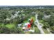 An aerial view shows the home with a spacious backyard, surrounded by mature trees and neighboring homes at 9413 Forest Hills Dr, Tampa, FL 33612