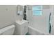 Bathroom with a tub-shower combination with a window at 9413 Forest Hills Dr, Tampa, FL 33612