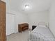 Small bedroom featuring a closet, piano, and twin bed with patterned comforter at 9413 Forest Hills Dr, Tampa, FL 33612
