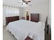 Bedroom featuring two dressers and large bed with white quilt at 9413 Forest Hills Dr, Tampa, FL 33612