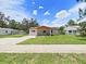 This charming single-story home features a well-manicured lawn, driveway and welcoming front porch at 9413 Forest Hills Dr, Tampa, FL 33612